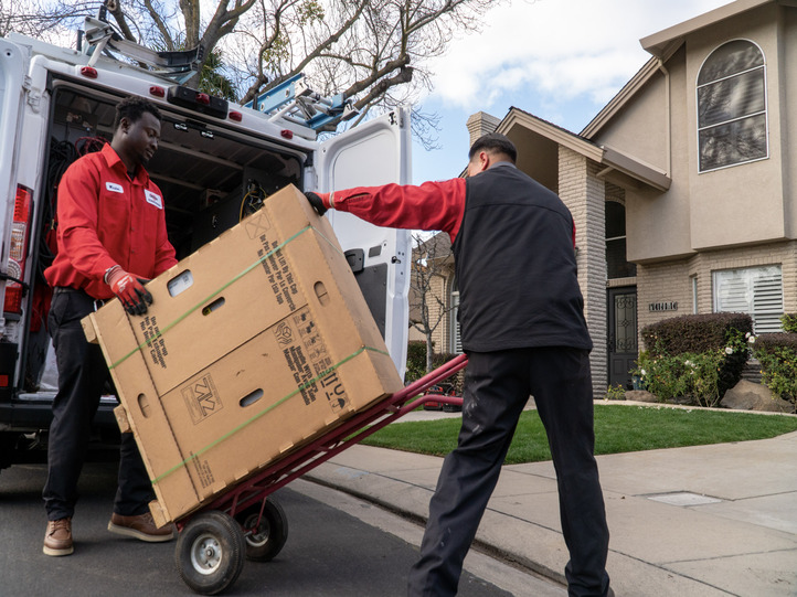 DeHart Techs Unloading a New HVAC Unit