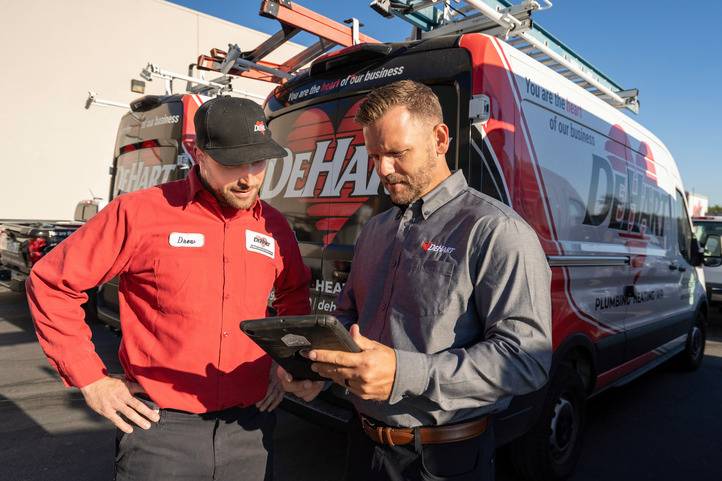 DeHart HVAC Experts Reviewing Tablet