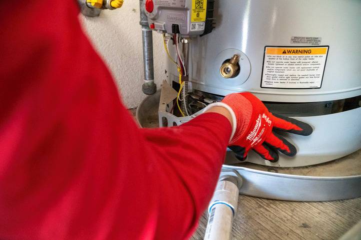 DeHart Technician Installing a Tank Water Heater
