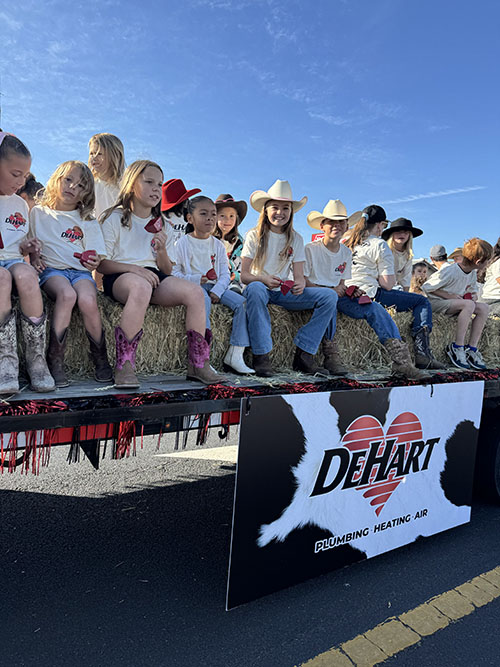 Modesto Rodeo - little girls sitting on hay