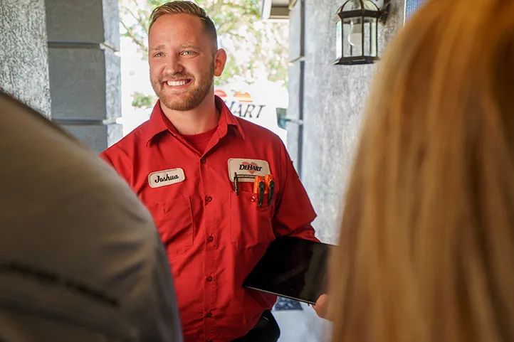 A Dehart technician speaking to customers