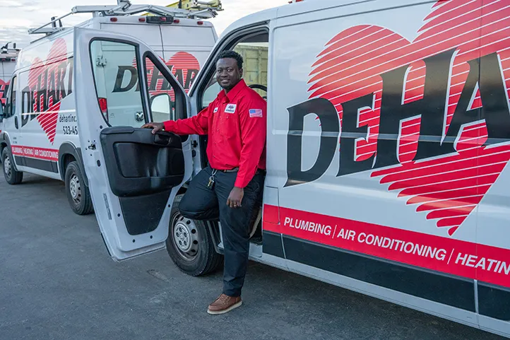 A Dehart technician exiting their van