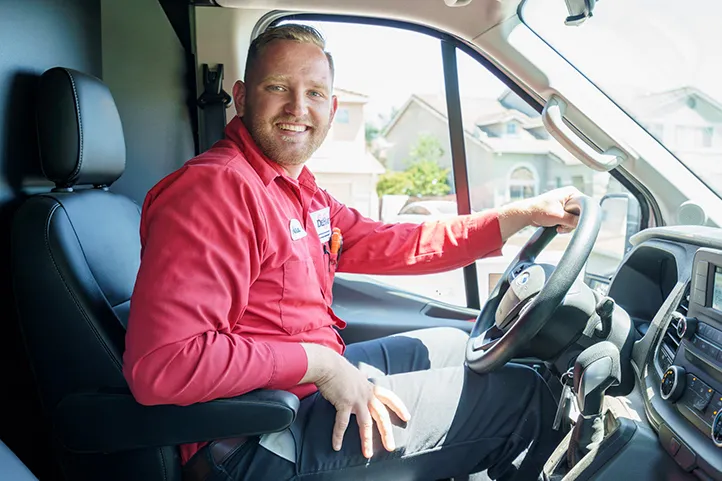 A Technician sitting in a Dehart van