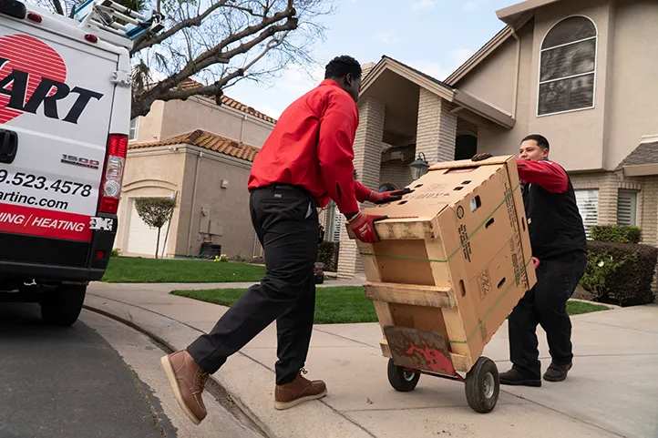 A Dehart technician unloading a new AC system