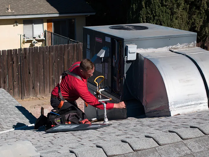A Dehart technician installing an AC system