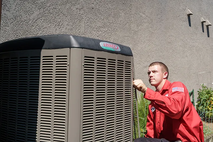 A Dehart performing maintenance on an AC unit