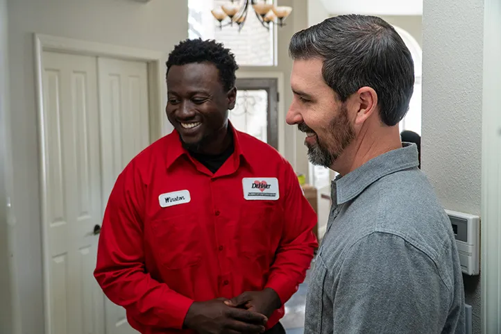 A Dehart technician with a happy customer