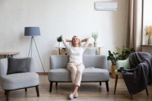 woman-leaning-back-on-couch-looking-comfortable-in-her-home