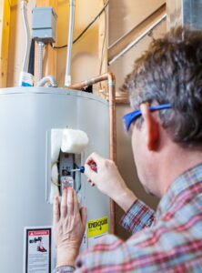 technician-working-on-water-heater-tank