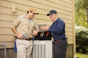two-techs-working-on-outdoor-ac-unit