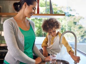 mom-and-son-getting-water-from-sink