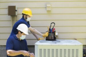 two-techs-working-on-outdoor-ac-unit