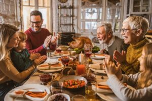 family-gathered-around-table-at thanksgiving
