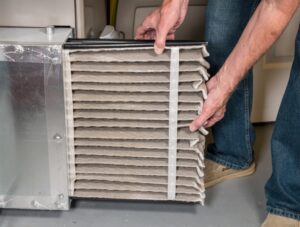 dirty-air-filter-being-pulled-out-of-hvac-system