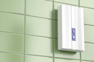 tankless-water-heater-on-green-tiled-wall